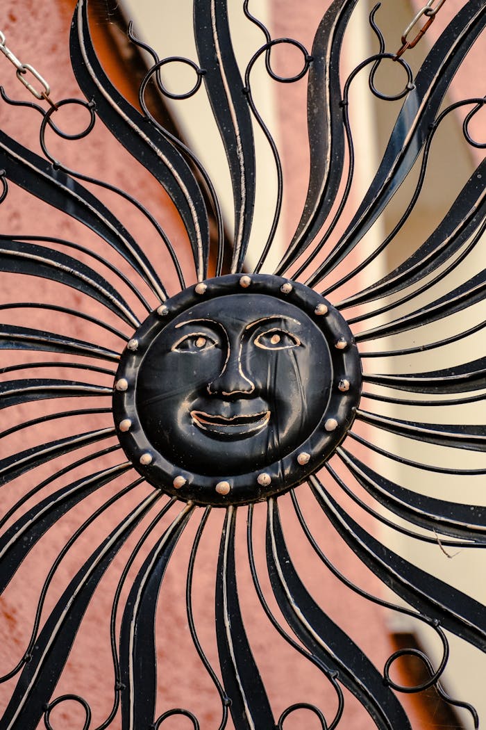 Intricate metal sun wall decoration with artistic flair and smiling face.